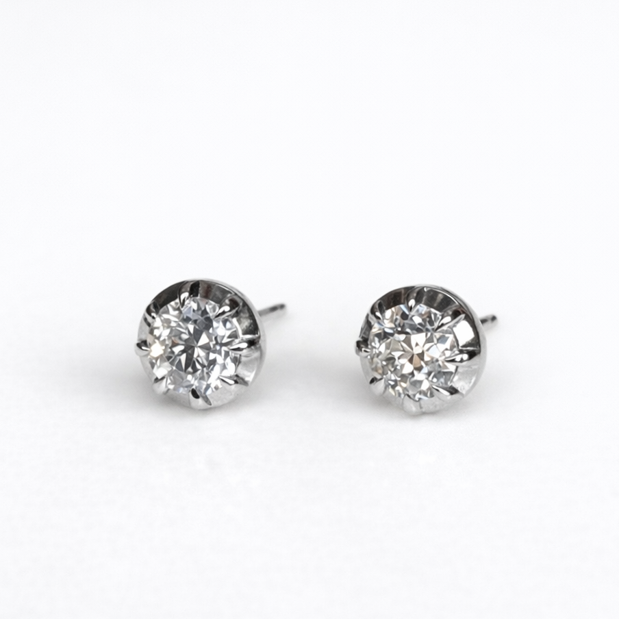 Pair of diamond stud earrings on a white background