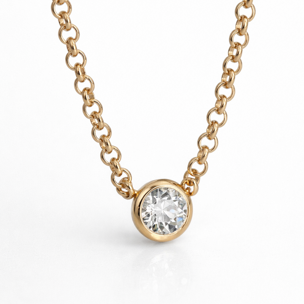 Gold necklace with a diamond pendant on a white background