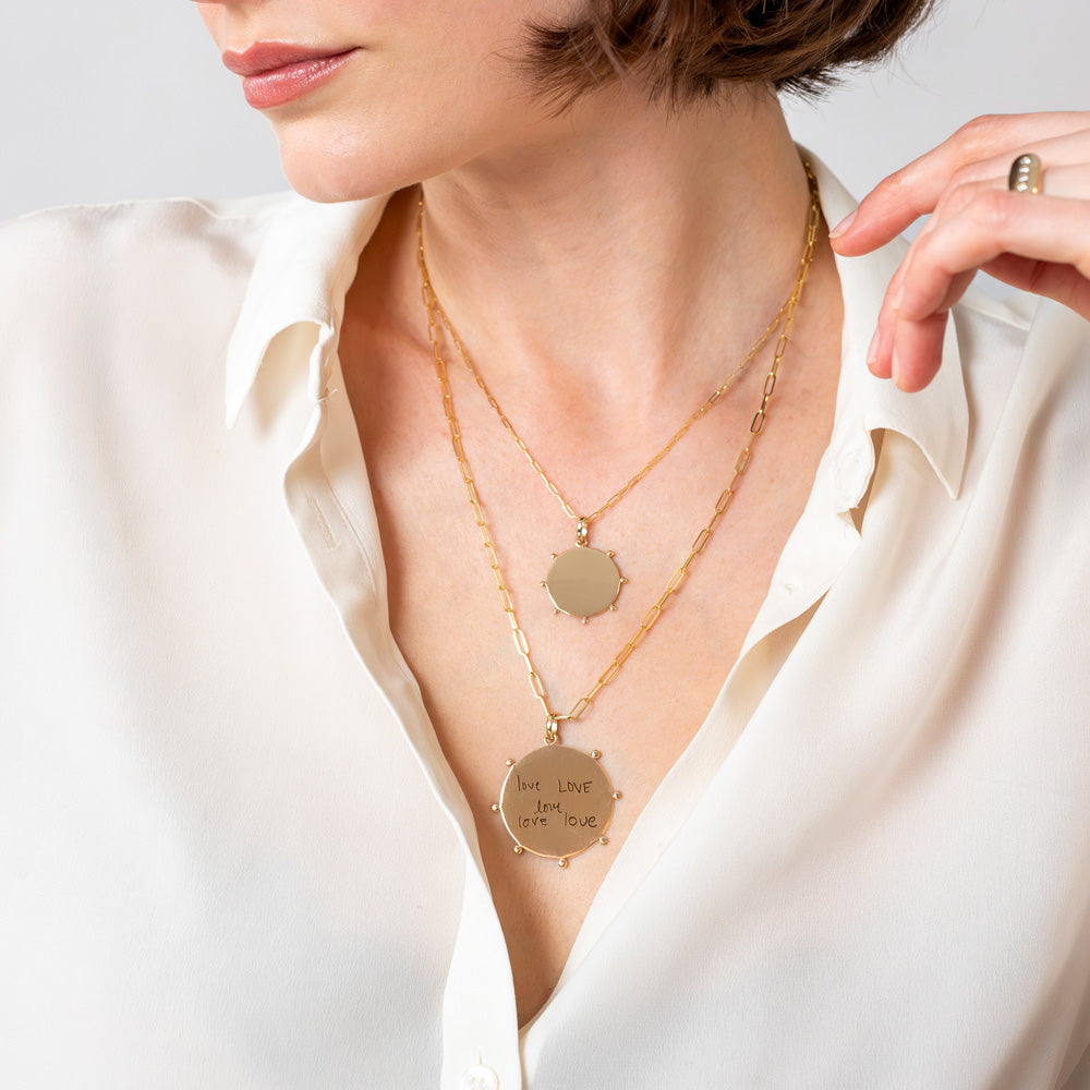 model showcasing both sizes of celestial medallions on paper clip chain necklaces